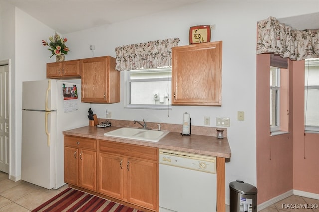 kitchen with white appliances, sink, and light tile patterned floors