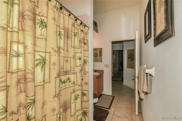 bathroom featuring toilet, vanity, and tile patterned floors