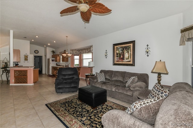 tiled living room featuring ceiling fan with notable chandelier and lofted ceiling