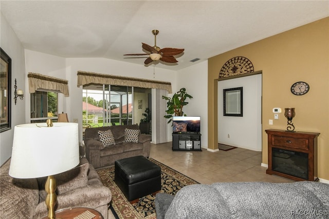 tiled living room featuring ceiling fan and lofted ceiling