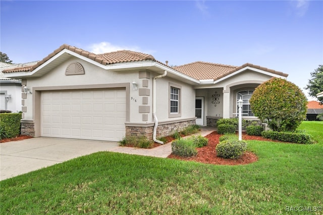 view of front of property with a front yard and a garage