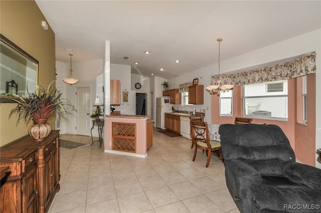 kitchen with light tile patterned floors, white appliances, and pendant lighting