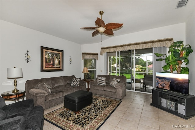 tiled living room featuring ceiling fan and vaulted ceiling