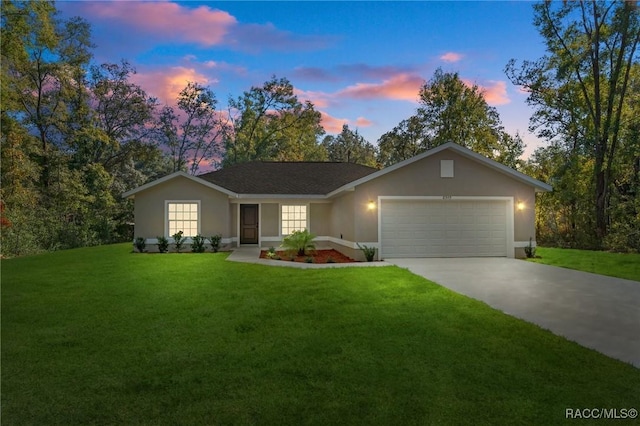 ranch-style home featuring a yard and a garage