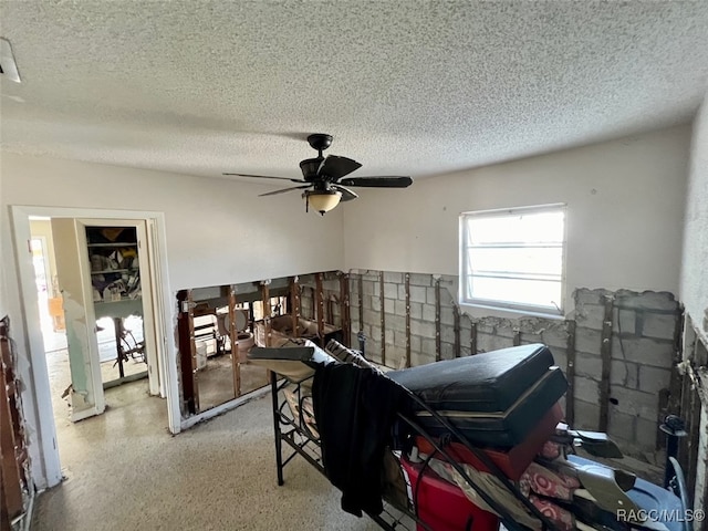 bedroom with a textured ceiling and ceiling fan