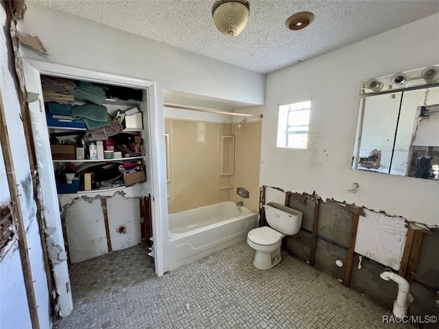 bathroom featuring shower / bathing tub combination, toilet, and a textured ceiling