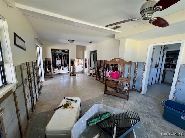 living room featuring plenty of natural light and ceiling fan