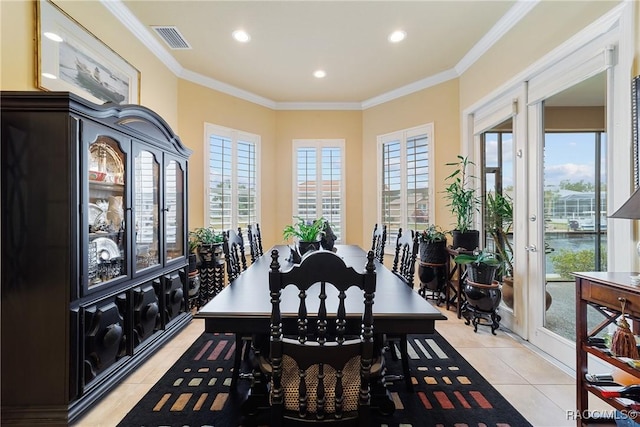 tiled dining space featuring french doors and crown molding