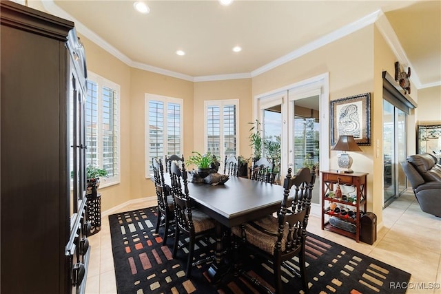 dining room with crown molding and light tile patterned floors