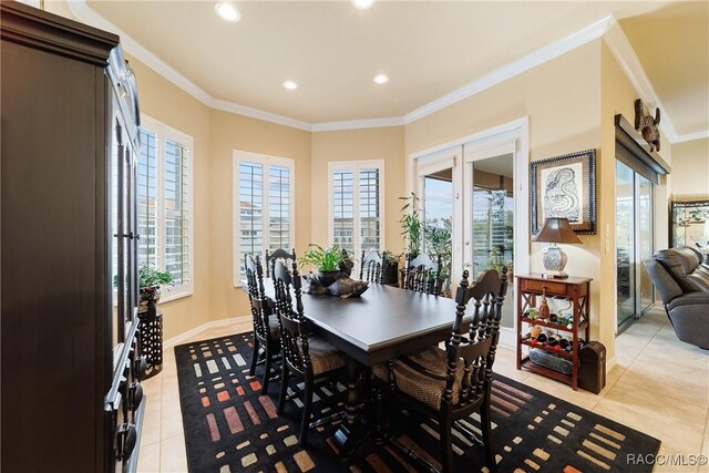 dining room with crown molding and light tile patterned floors