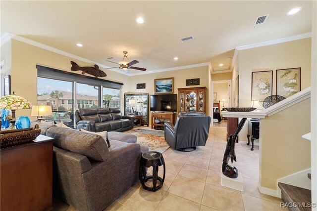 tiled living room with ceiling fan and ornamental molding