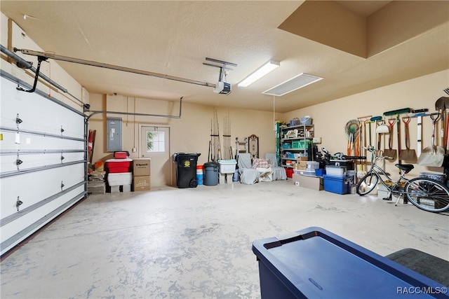 garage featuring electric panel and a garage door opener