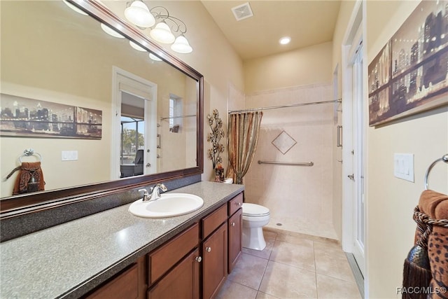 bathroom featuring vanity, tile patterned flooring, toilet, and curtained shower