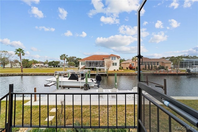 view of dock featuring a lawn and a water view