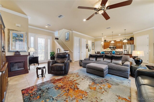 tiled living room featuring ceiling fan and crown molding