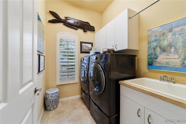 laundry area with sink, washer and clothes dryer, light tile patterned flooring, and cabinets