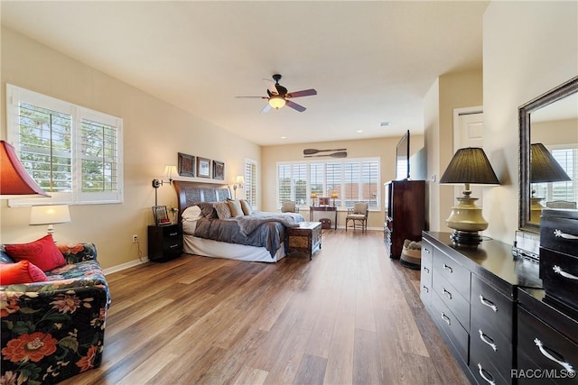 bedroom with ceiling fan and wood-type flooring