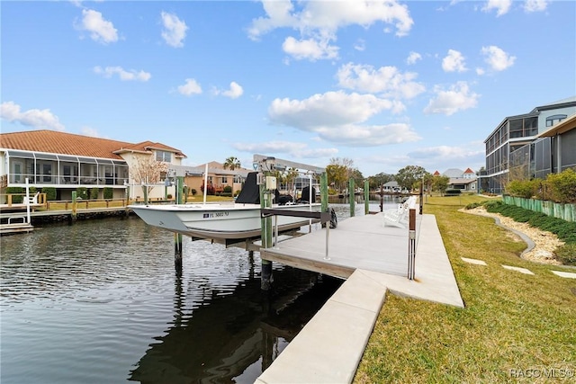 dock area featuring a water view and a lawn