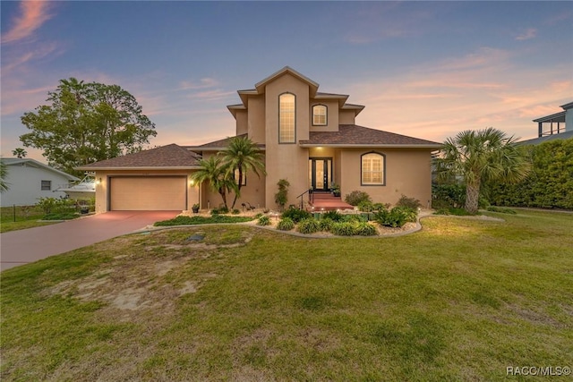 view of front of home featuring a garage and a lawn