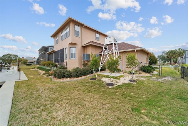 rear view of property featuring a lawn