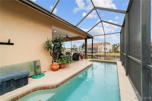 view of swimming pool with glass enclosure and a patio area