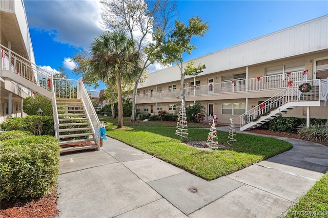 10038 62nd Ter N Unit 2, Saint Petersburg, FL 33708 - view of property's community with stairway and a lawn