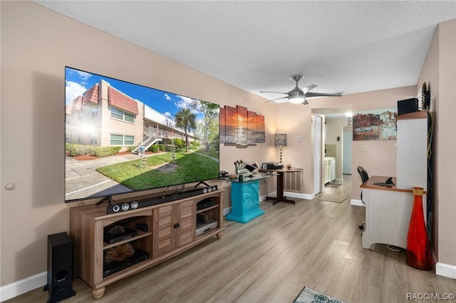 10038 62nd Ter N Unit 2, Saint Petersburg, FL 33708 - living area with wood finished floors, baseboards, a textured ceiling, and a ceiling fan