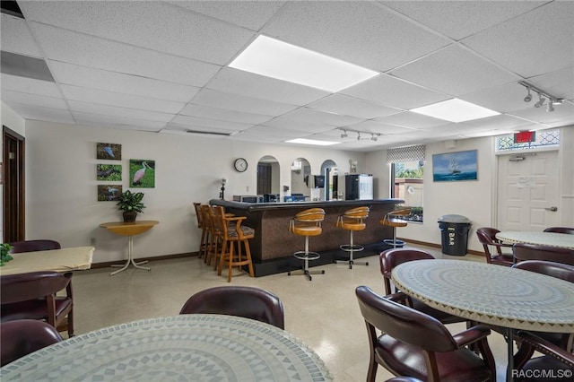 10038 62nd Ter N Unit 2, Saint Petersburg, FL 33708 - dining space featuring baseboards, a drop ceiling, a community bar, and rail lighting