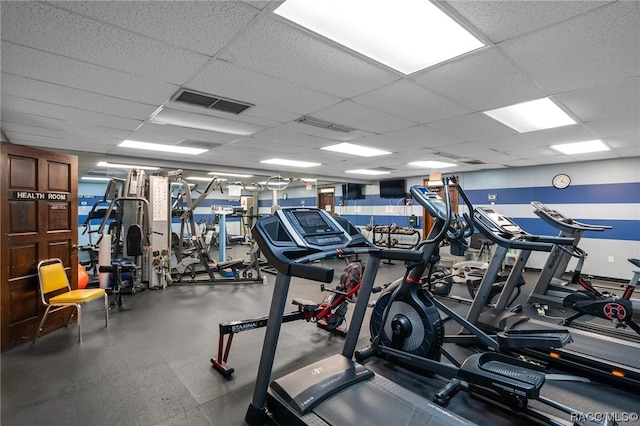 exercise room featuring a paneled ceiling