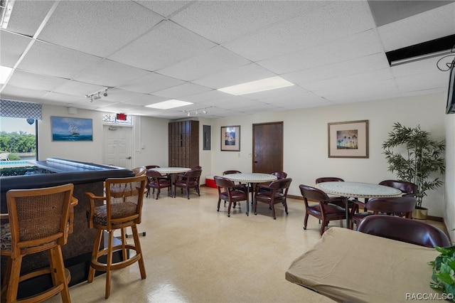 playroom with a paneled ceiling