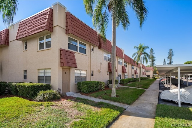 10038 62nd Ter N Unit 2, Saint Petersburg, FL 33708 - view of building exterior with a carport