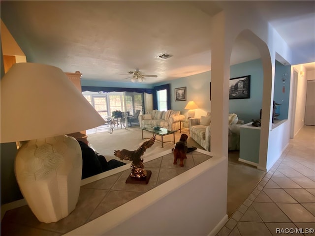 tiled living room with ceiling fan