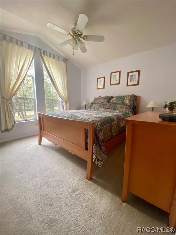 carpeted bedroom with ceiling fan and lofted ceiling