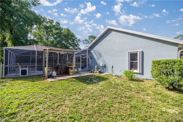 2 Nancy Pkwy, Yankeetown, FL 34498 - rear view of property with stucco siding, a patio area, a lanai, and a lawn