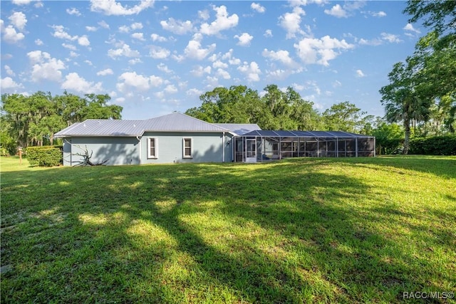 2 Nancy Pkwy, Yankeetown, FL 34498 - rear view of property featuring a lawn, a metal roof, and a lanai