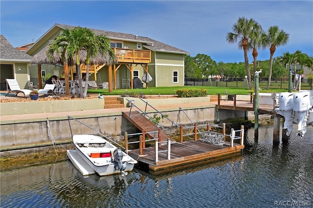 dock area featuring a water view and a lawn