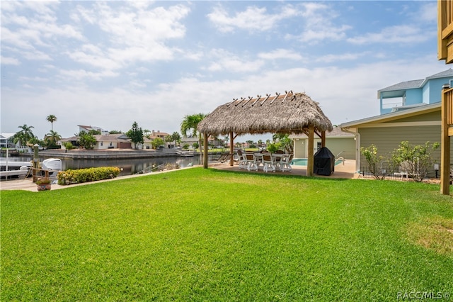 view of yard featuring a gazebo and a water view