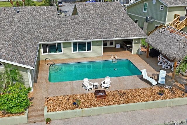 view of swimming pool with central air condition unit, a patio area, and a gazebo