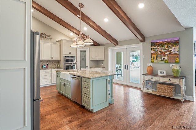 kitchen featuring light stone countertops, stainless steel appliances, a kitchen island with sink, dark wood-type flooring, and lofted ceiling with beams