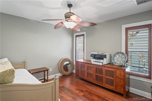 bedroom with ceiling fan and dark hardwood / wood-style flooring