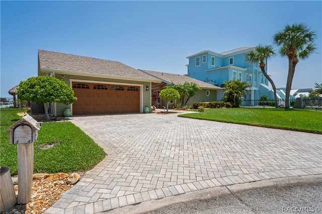 view of front of home featuring a garage and a front lawn