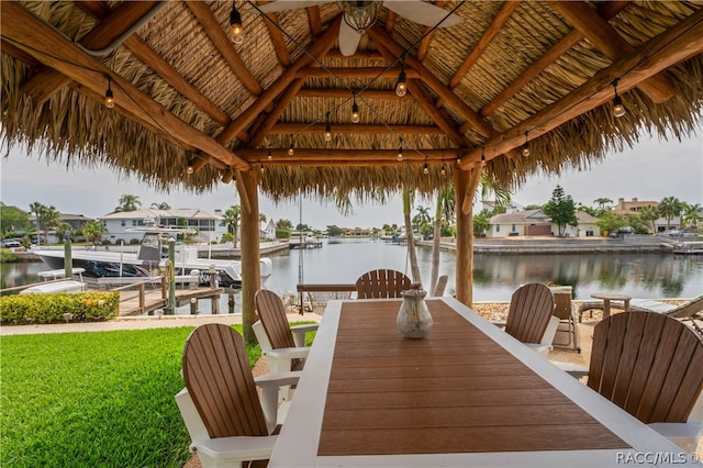 view of dock featuring a gazebo, a lawn, and a water view