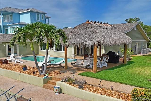 view of pool with a gazebo, a patio area, a yard, and central air condition unit