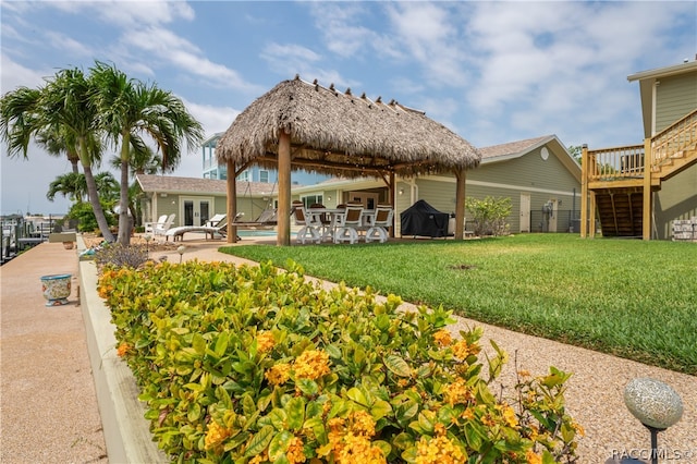 back of house with a yard, a swimming pool, a patio, and french doors