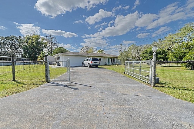 manufactured / mobile home featuring a garage and a front lawn