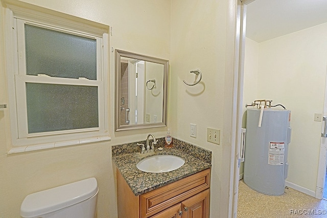 bathroom featuring vanity, toilet, and water heater