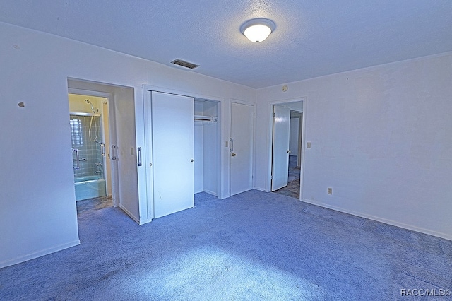 unfurnished bedroom featuring a closet, carpet, and a textured ceiling