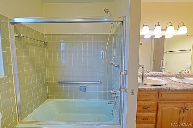 bathroom with tiled shower / bath and vanity