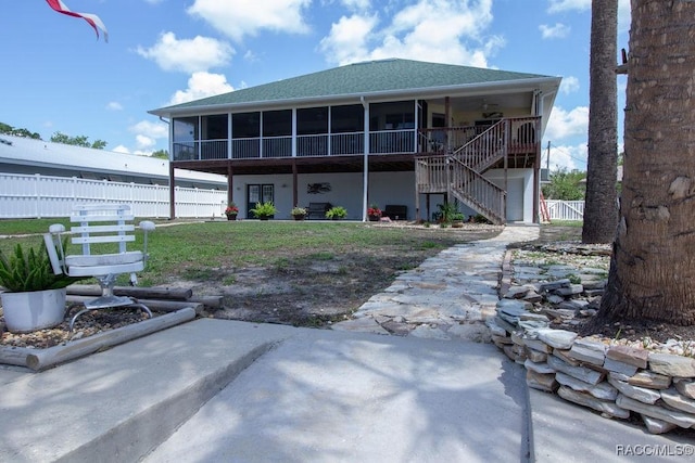1930 NW 18th St, Crystal River, FL 34428 - back of property with a sunroom, stairs, a patio, a ceiling fan, and roof with shingles