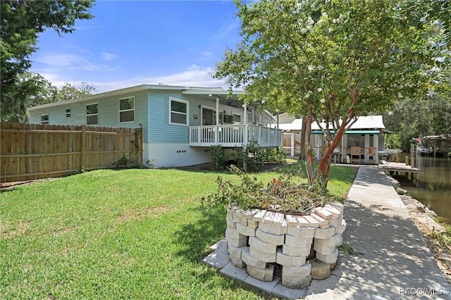 exterior space featuring a lawn and a deck